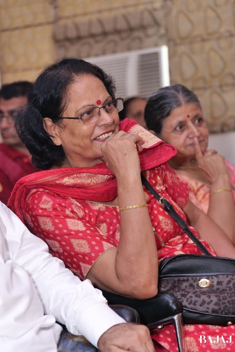 Mahima Ma'am sharing a warm smile at a community gathering